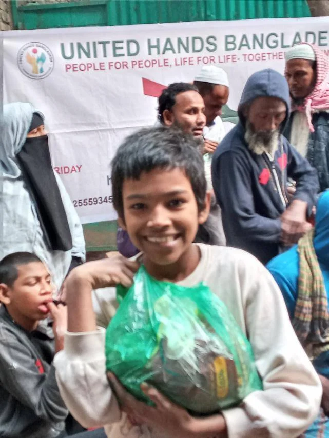 Smiling boy receiving food package with joy